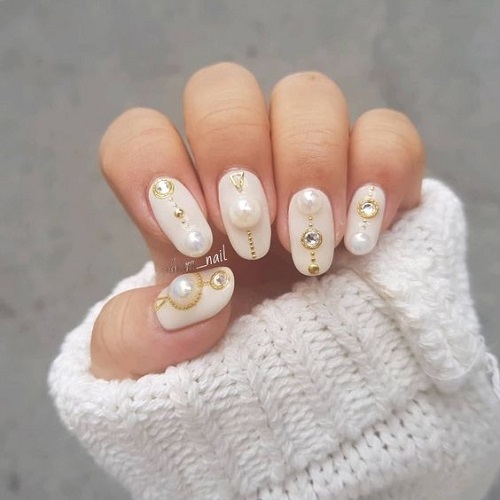 Nails Decorated With Diamonds, Pearls, and Gold