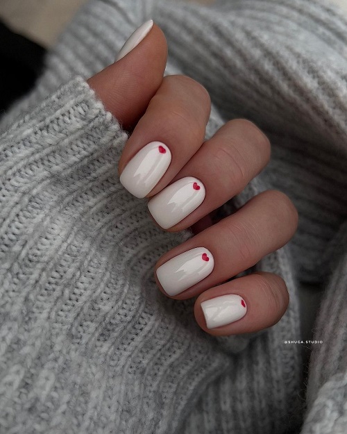 White Nails Ornamented With Tiny Red Hearts